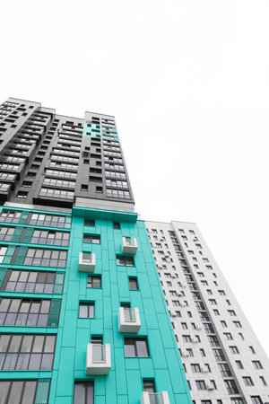 Modern high-rise apartment buildings in a vibrant residential area showcasing varied architectural...