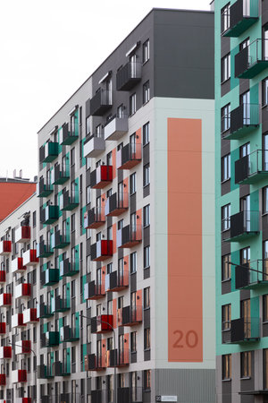 High-rise apartment buildings in a residential area with varied balcony colors and modern architecture for renters and homeownersの写真素材