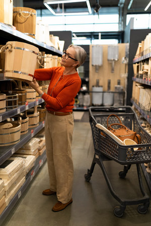 Senior woman explores home goods aisle while shopping for storage baskets in a modern retail store