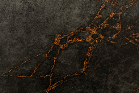 Dark marble surface with golden veins creates a luxurious backdrop for various design projectsの写真素材