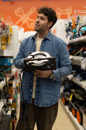 Man shopping for power tools in a diy store for home improvement project