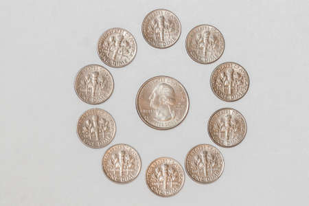 American dime coins in a circle around a quarter