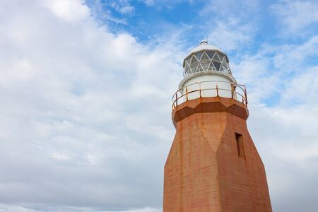 Faded red Long Point Lighthouse in Newfoundland.の写真素材