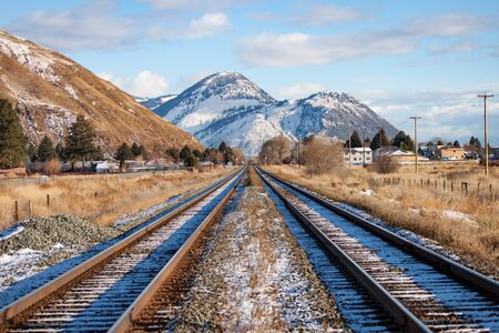 Two Tracks Leading to Mountains in Winterの写真素材