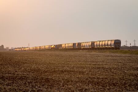 Freight Train Under Golden Sunrise on the Prairie