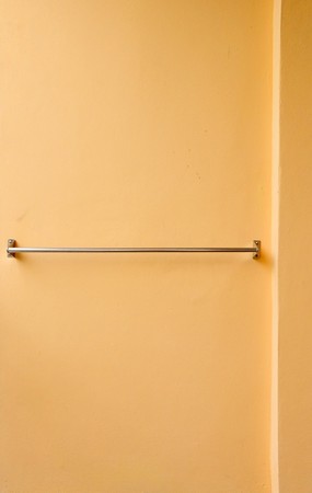 The metal clothes line on orange wallの写真素材