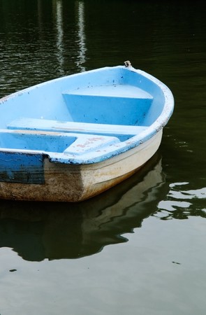 Lonely blue boat in the lake of resort