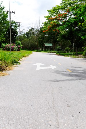 The arrow directions on the road in the countrysideの写真素材