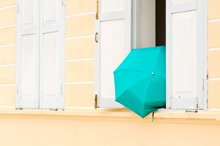  green umbrella outside the windowの写真素材