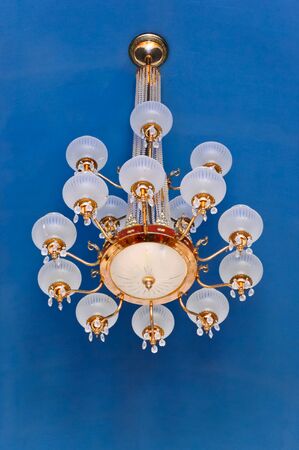 Classic chandeliers hanging on the blue wall of royal palace,Thailandの写真素材