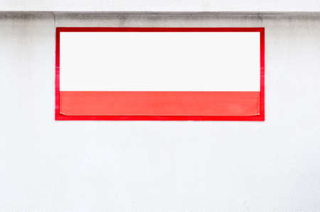 Old notice board on the white wall of office building.の写真素材