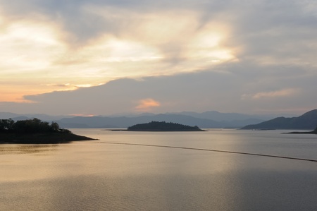 Sunset on the tranquil lake of great dam on westhern of Thailand.
