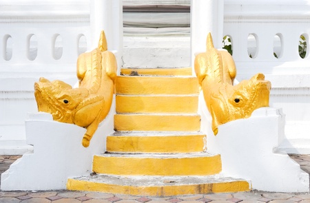 Golden lion statues on the white stair to the pagoda.の写真素材
