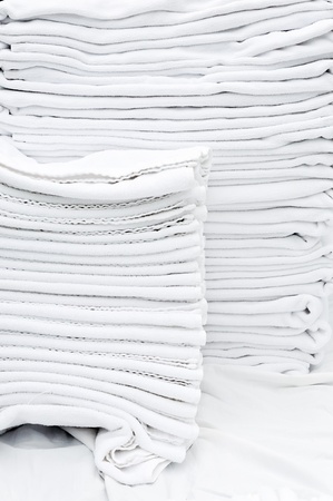 Pile of white towels in the service room of hotel.の写真素材