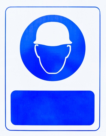 The blue helmet symbol in front of the construction sites of large building.の写真素材