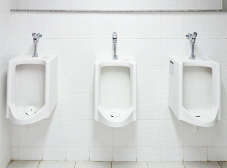 White urinal in the restroom of hotel.