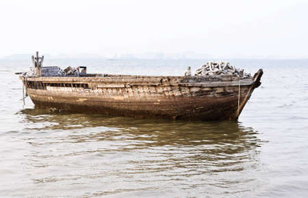 Old lonely boat near the harbor in early morning.