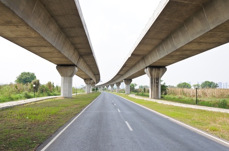 Empty asphalt road under the new expressway line.