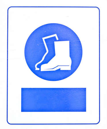 The blue boots symbol in front of the construction sites of large building.の写真素材