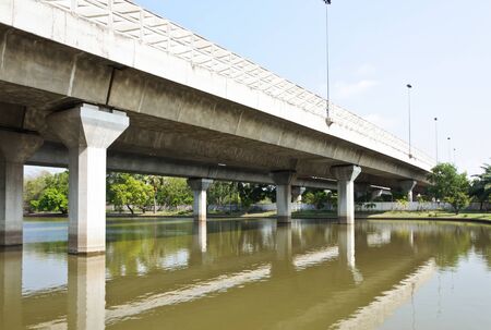 Expressway bridge on the reservoir of urban park の写真素材