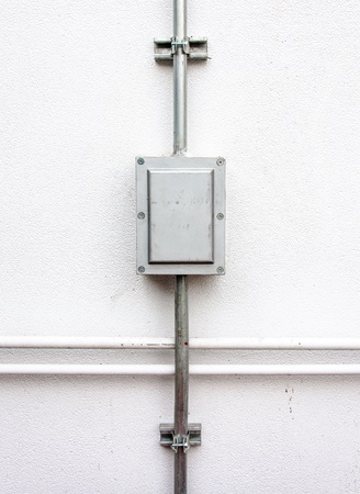 Electric control box on the white wall of factory 