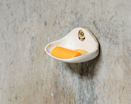 Old dish soap on the wall of bathroom 