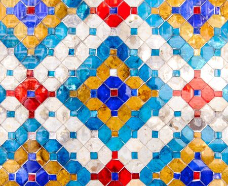 Traditional Thai mosaic art on the wall of temple 