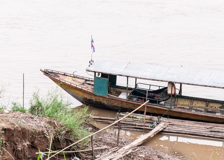 Traditional Thai long tail boat on large river near the border of Thailand の写真素材