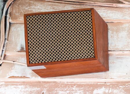 Retro style speaker box on the wall of old house 