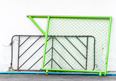 Metal barrier is leaning on the white wall の写真素材