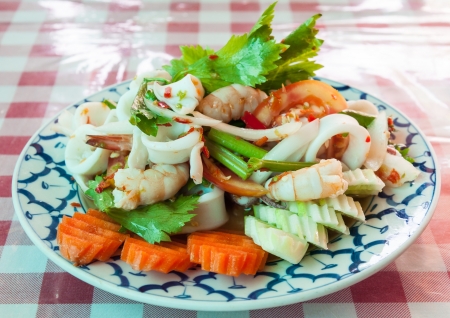 Traditional Thai spicy salad with shrimp and squid in the restaurant の写真素材