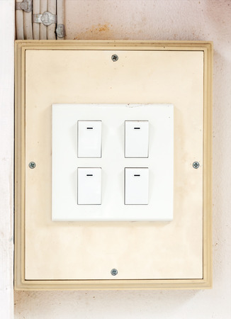 White switch on the old wall of rural house.の写真素材