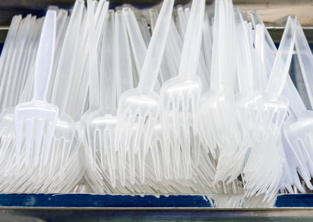 White plastic fork on the metal tray.