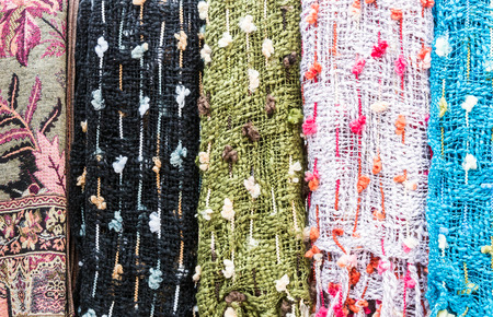 Colorful scarf is hanging in the handicraft shop.