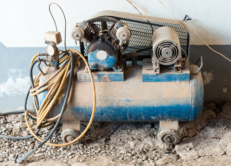 Old air compressor for small garage in the countryside.