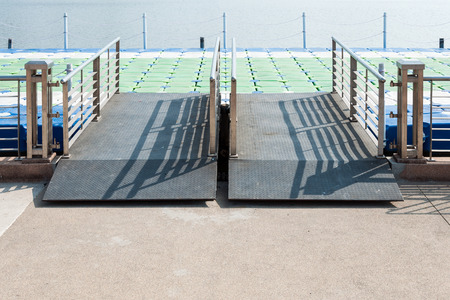 Matel bridge to the colorful pontoon on small lake.の写真素材
