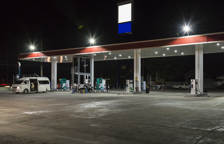 Large gas station in the urban of Thailand at night.の写真素材