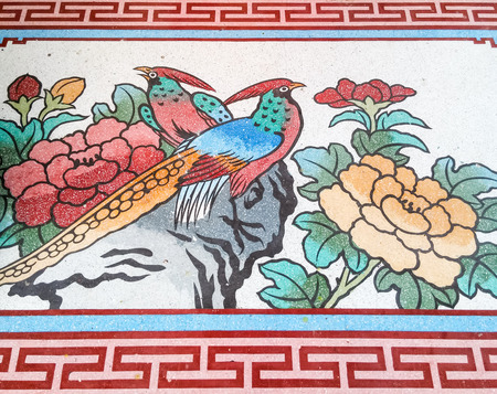 Peacock painting in traditional Chinese style of the Thai temple.の写真素材