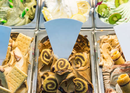 Fresh gelato icecream with variety topping in the homemade shop.
