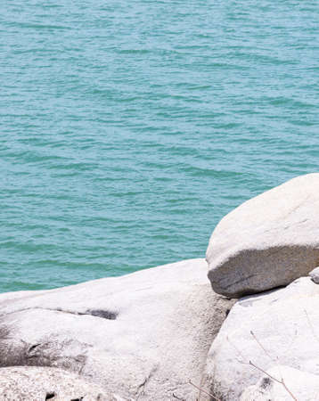 White rock cliff near the clear blue sea in the southern of Thailand.