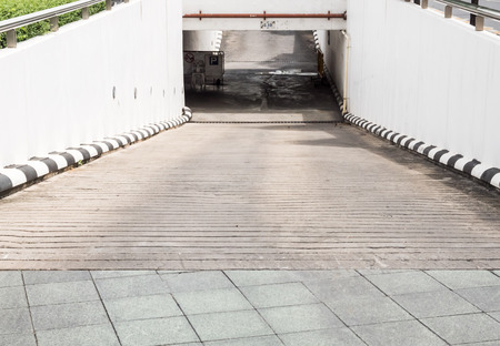 Concrete slope way to the underground parking building of the urban park.の写真素材