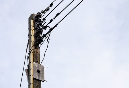 Old electric pole for use in the rural village of Thailand.