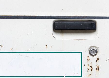 Black old handle with the white label of the rusty van for use in the airport.の写真素材