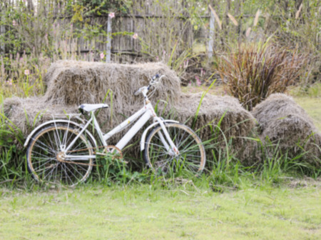 Old white bicycle near the straw in the country of Thailand with the blur focus.の写真素材