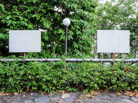 Double white board on the metal pole in the park.の写真素材