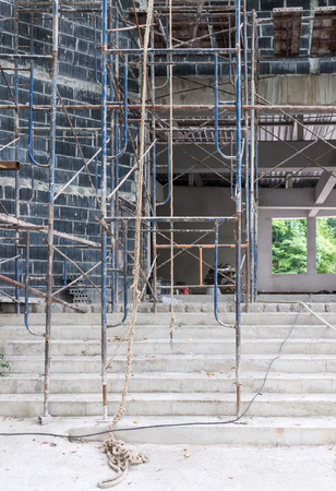 Old metal scaffolding in front of the Unfinished building.の写真素材
