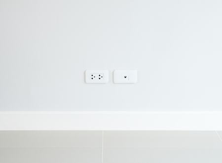 New outlet and telephone socket on the white house wall.