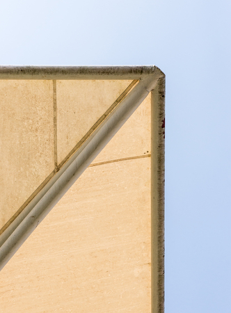 Old canvas canopy with the metal white frame of the modern parking under the clear blue sky.