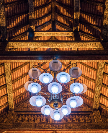 Large luxury chandelier is hanging on the wooden beam of the Thai church.(Public area not required Property Release)の写真素材