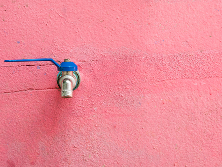 Old blue faucet on the red concrete wall in the local primary school,Thailand.(copy space)の写真素材